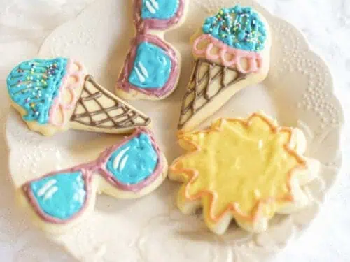 sunglasses, sun, ice cream cookies on a plate.